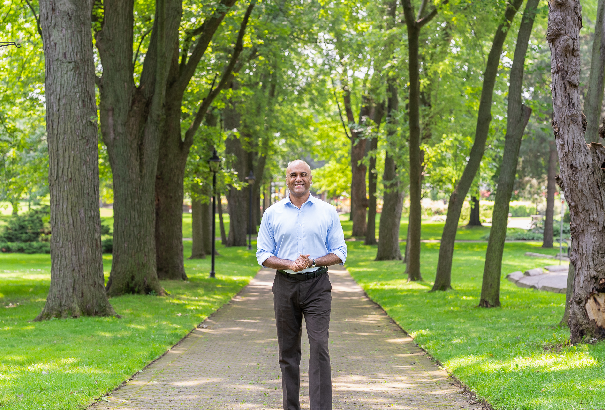 Parthi Kandavel standing on a tree-lined path in a Scarborough park